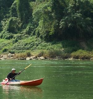 a man in a canoe on a river