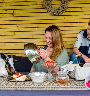a woman and boy sitting at a table with food