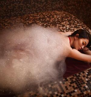 a woman laying on the floor in a bath tub