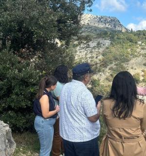a group of people standing on the side of a mountain