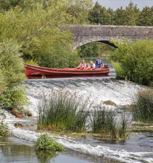 skupina lidí v lodi na řece