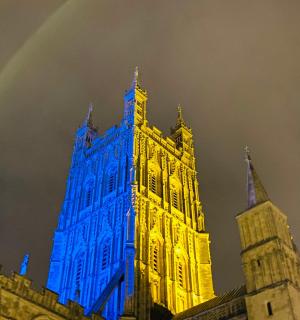 a building with blue lights on it with a rainbow
