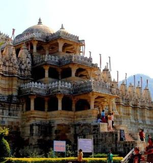 a large building with people standing in front of it