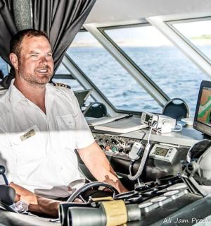 a man sitting in the helm of a boat