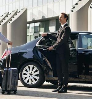 two men walking out of a car with their luggage