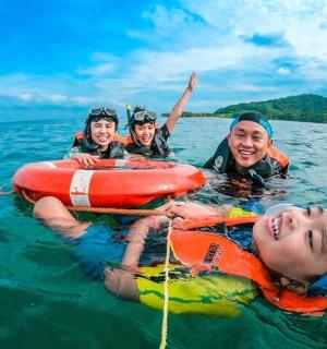 a group of people in the water on a raft
