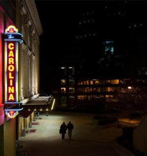 two people walking down a street at night