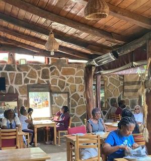 a group of people sitting at tables in a restaurant