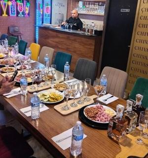a woman sitting at a long table with plates of food