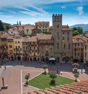 a city square with buildings and a clock tower