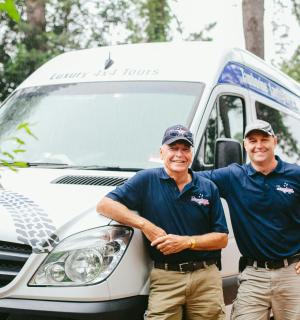 two men are standing in front of a van