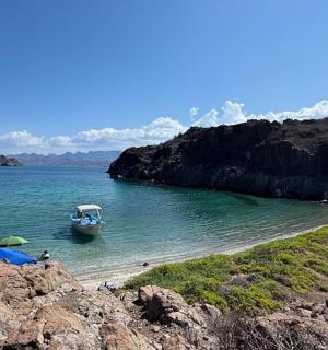 a boat in the water on a beach