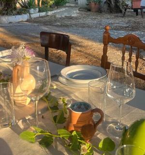 a table with wine glasses and plates on it