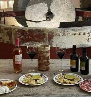 a table with wine bottles and plates of food and wine glasses