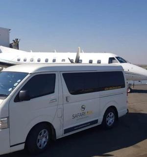 a white van parked in front of an airplane
