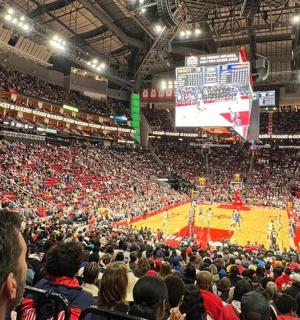 a crowd of people watching a basketball game in a stadium