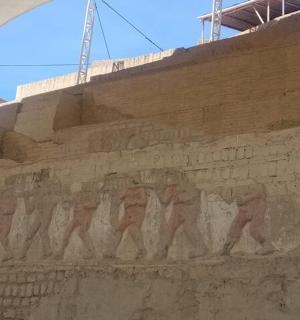 a wall with a mural of men walking on it