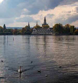 a large building on the water with ducks in it