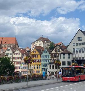 a red bus driving down a city street with buildings