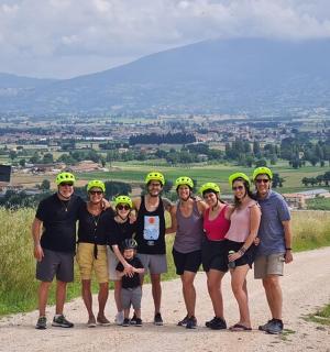 a group of people wearing helmets standing on a dirt road
