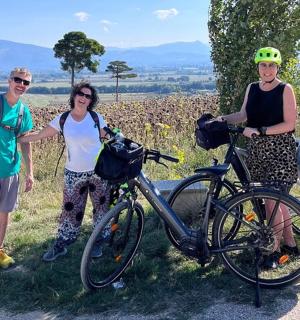 a group of people standing next to a bike