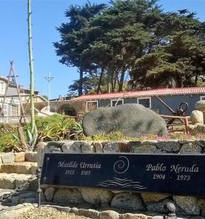 a sign for a zoo with a elephant in the background