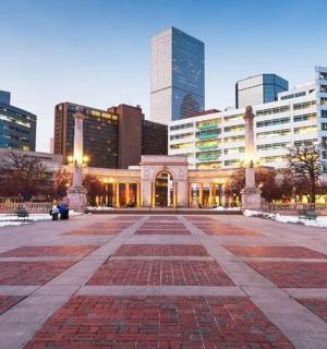 a large building in a city with tall buildings