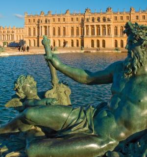 a statue in the water in front of a building