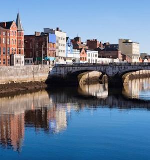 a bridge over a river in a city with buildings