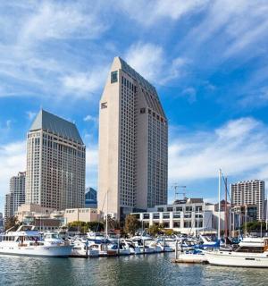 a group of boats docked in a harbor with a city