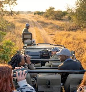 a group of people riding in a safari truck