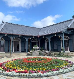 a building with a flower garden in front of it