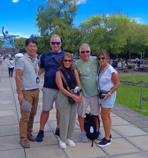 a group of people posing for a picture in a park