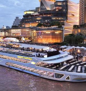 two cruise ships docked in the water in a city
