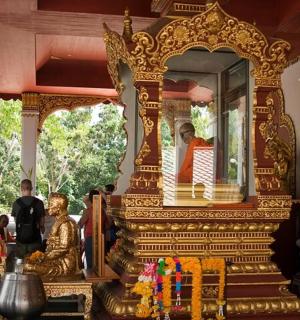 a man standing in front of a mirror in a temple