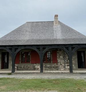 a red house with a roof with a porch