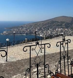 a view of a city and the ocean from a hill