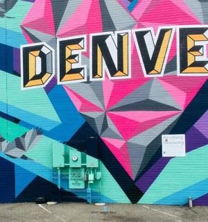 a wall covered in graffiti with the word danger on it