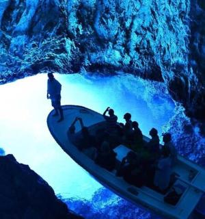 a group of people on a boat in a cave