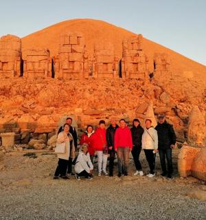 a group of people standing in front of a pyramid