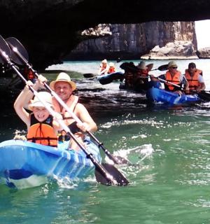 a woman and a child are in kayaks in the water