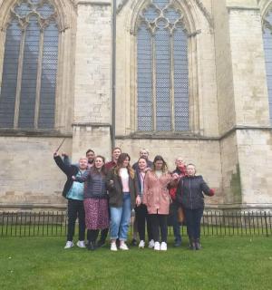 a group of people standing in front of a church