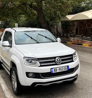 a white car parked on the side of a street