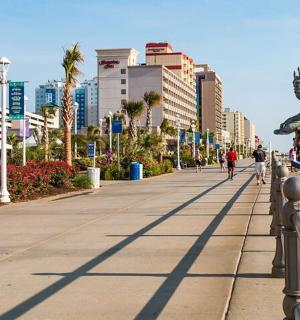 a person riding a skateboard on a rail on a beach