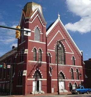 a red and white church with a traffic light