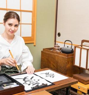 a woman holding a chopstick in front of a table
