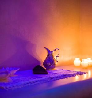 a table with a vase and candles on it