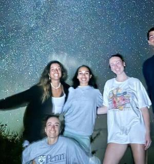 a group of people posing for a picture under the stars