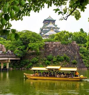 a yellow boat in the water in front of a building