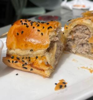 a plate with a sandwich and a bowl of sauce